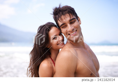 Embracing, beach and portrait of couple on vacation, adventure or holiday for romantic travel. Happy, love and young man and woman on date by ocean for tropical outdoor anniversary weekend trip. 141182014