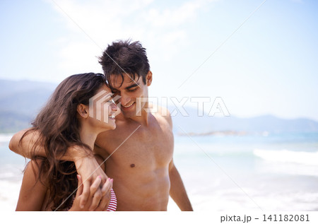 Beach, love and couple with vacation, summer and weekend break for honeymoon and adventure. Travel, seaside and embrace with man and woman with holiday and love with anniversary, happiness and ocean Beach, love and couple with vacation, summer and weekend break for honeymoon and adventure. Travel, seaside and embrace with man and woman with holiday and love with anniversary, happiness and ocean 141182081