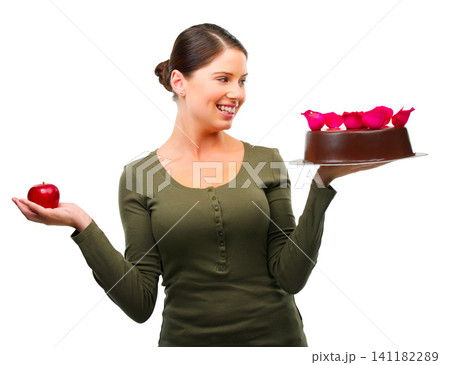 Woman, apple and cake for choice in studio with smile, thinking and ideas for diet by white background. Girl, person and model with bakery snack, fruit and decision for health, wellness or nutrition Woman, apple and cake for choice in studio with smile, thinking and ideas for diet by white background. Girl, person and model with bakery snack, fruit and decision for health, wellness or nutrition 141182289