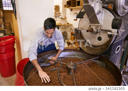 Coffee beans, blend and man with machine for roasting with small business, production and quality control. Entrepreneur, barista or worker with grain at cafe, sustainable startup and espresso process 141182303