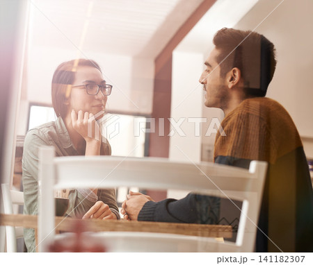 Couple, relax and talking with date for conversation, bonding or romance at indoor restaurant. Man and woman with smile by window at coffee shop for social communication or chatting together at table Couple, relax and talking with date for conversation, bonding or romance at indoor restaurant. Man and woman with smile by window at coffee shop for social communication or chatting together at table 141182307