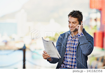 Cellphone, newspaper and man in outdoor for hiring, interview or phone call. Newsletter, happy and male person with smartphone for recruitment, conversation and discussion for employment opportunity 141182358