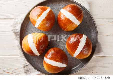 Homemade Maritozzo italian pastry with whipped cream close-up in a plate. Horizontal top view 141182386