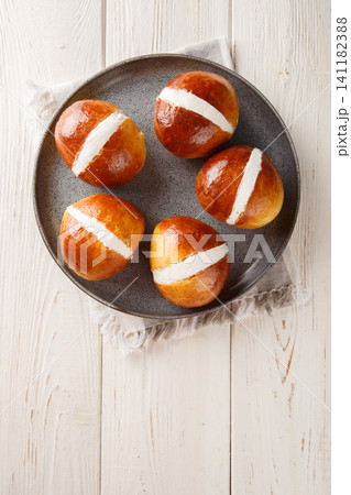 Homemade Maritozzo is Italian bread stuffed with whipped cream close-up in a plate. Vertical top view 141182388