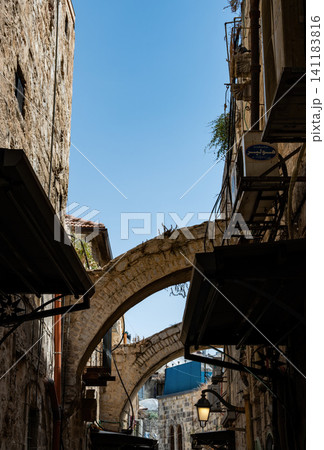 A narrow street among stone houses in old Jerusalem, Israel. A narrow street among stone houses in old Jerusalem, Israel. 141183816