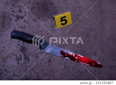 Bloody Knife with Yellow Evidence Marker Number 5 at Crime Scene 141183867