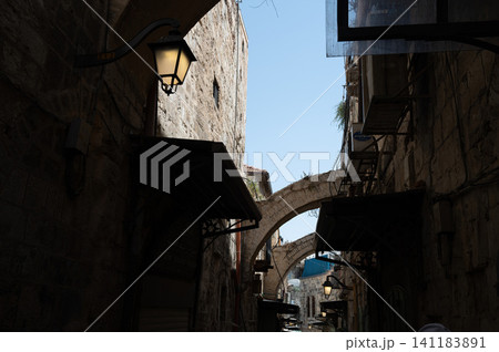 A narrow street among stone houses in old Jerusalem, Israel. A narrow street among stone houses in old Jerusalem, Israel. 141183891