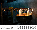 Burning church candles in an ancient temple in the darkness 141183910