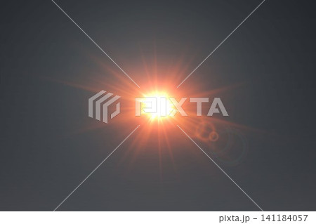 Bright sun creating warm light rays and optical lens flares on a dark background 141184057