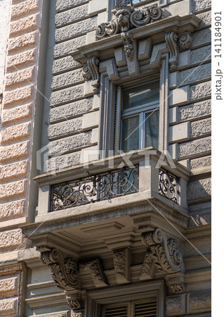 Classic Building Facade with Ornate Window and Stone Balcony with Wrought Iron Railing in Milan Classic Building Facade with Ornate Window and Stone Balcony with Wrought Iron Railing in Milan 141184901
