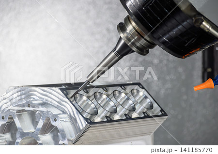 High-precision 5-axis CNC milling machine performing a finish cut on an aluminum V8 engine block with a flat nose end mill tool. 141185770