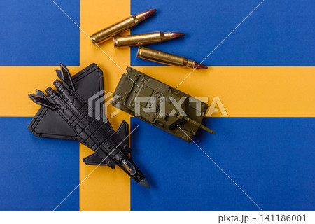 A fighter jet against the Swedish flag as a conceptual background representing defense A fighter jet against the Swedish flag as a conceptual background representing defense 141186001