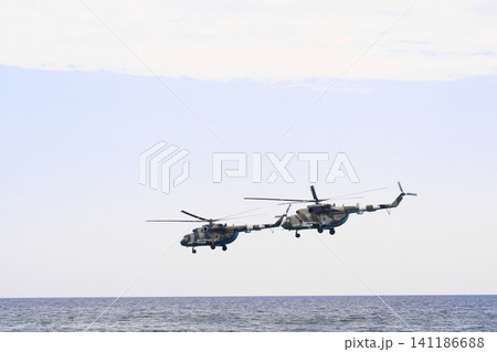 military helicopters flying over ocean, military helicopters flying over ocean, 141186688