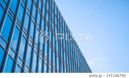 A tall building with a blue sky in the background A tall building with a blue sky in the background 141186700