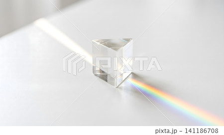 A white diamond with a rainbow light coming from it 141186708