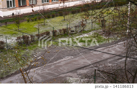 hail remains visible on road and green grass after storm, hail remains visible on road and green grass after storm, 141186813