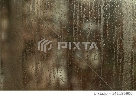 water drops on glass forming abstract background, 141186906
