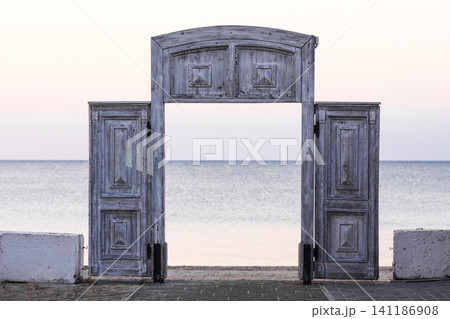 Wooden gate opening to calm sea, Wooden gate opening to calm sea, 141186908