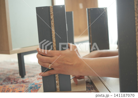 Building a stylish furniture piece with careful hands Building a stylish furniture piece with careful hands 141187070