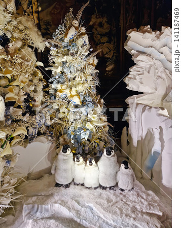 Maincy, France - December 11, 2025: Family of plush penguins on faux snow and winter trees in background. Magical Christmas holiday decor inside the historic Vaux-le-Vicomte Chateau Maincy, France - December 11, 2025: Family of plush penguins on faux snow and winter trees in background. Magical Christmas holiday decor inside the historic Vaux-le-Vicomte Chateau 141187469