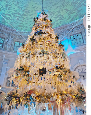 Maincy, France - December 11, 2025: A towering Christmas tree in a grand hall, decorated in a unique aquatic theme, with golden and white ornaments inside the historic Vaux-le-Vicomte Chateau 141187471