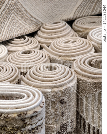 Decorative floor carpets in warm tones arranged in a megastore presenting elegant textures and stylish home decoration concepts Decorative floor carpets in warm tones arranged in a megastore presenting elegant textures and stylish home decoration concepts 141188044