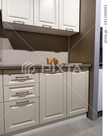 Kitchen design setups arranged in a store to allow customers to compare functionality and aesthetics Kitchen design setups arranged in a store to allow customers to compare functionality and aesthetics 141188081