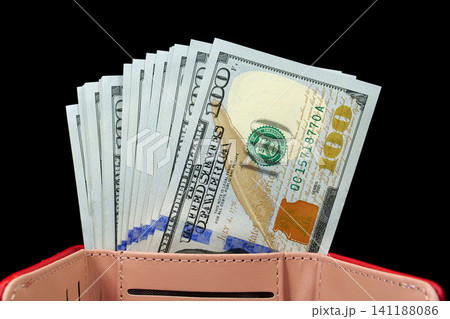 American dollars in wallet. Cash, finance, savings, wealth. New hundred dollar bills in a leather wallet. A wad of money. New 100 dollar bills, USD American dollars in wallet. Cash, finance, savings, wealth. New hundred dollar bills in a leather wallet. A wad of money. New 100 dollar bills, USD 141188086