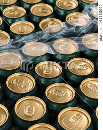 Golden and green aluminum beer cans arranged in bulk at supplier warehouse ready for logistics and retail supply chain Golden and green aluminum beer cans arranged in bulk at supplier warehouse ready for logistics and retail supply chain 141188090