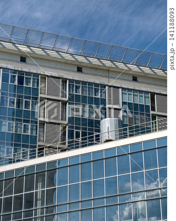 High rise residential tower with minimal facade and modern apartment balconies in urban district 141188093