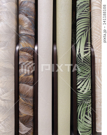 Modern wallpaper rolls displayed on shelves in a home improvement store, ready to be chosen for various renovation projects Modern wallpaper rolls displayed on shelves in a home improvement store, ready to be chosen for various renovation projects 141188108