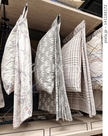 Soft bedding pillows displayed on shelves in urban home outlet 141188172