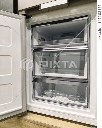 Sleek refrigerator with open freezer door, available for purchase in a superstore Sleek refrigerator with open freezer door, available for purchase in a superstore 141188185