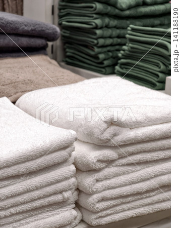 Neatly folded white soft towels on home products shelf in store Neatly folded white soft towels on home products shelf in store 141188190