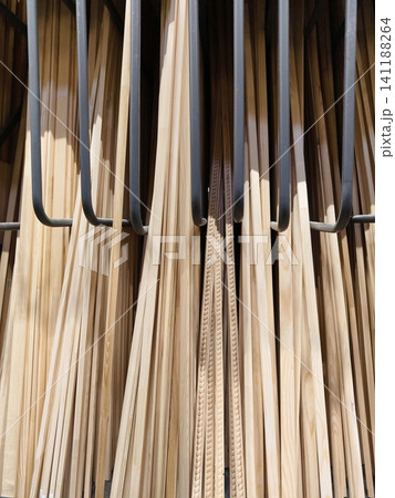 Boards, slats and wood products arranged in shelf section of construction supermarket Boards, slats and wood products arranged in shelf section of construction supermarket 141188264
