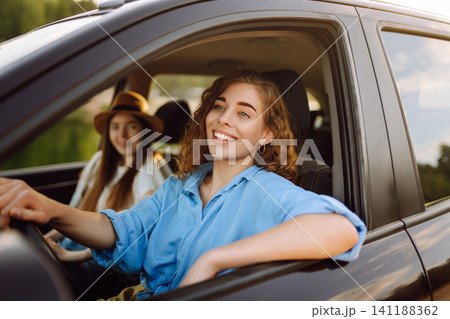 Two Young woman is resting and enjoying trip in car Automobile journey, traveling, lifestyle concept 141188362