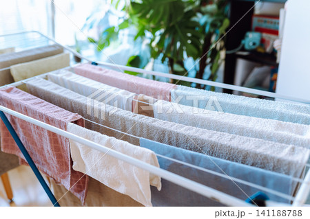 clothes are dried on a clothes dryer indoors clothes are dried on a clothes dryer indoors 141188788