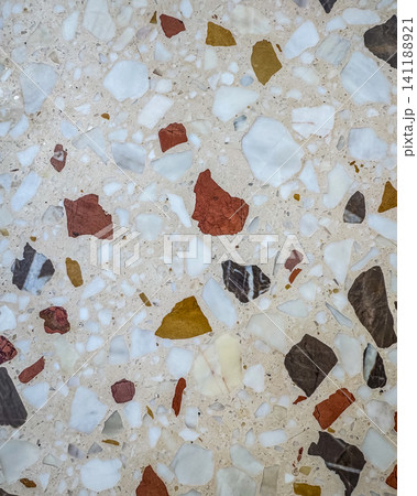 Warm toned terrazzo stone surface with mixed marble aggregate in cream white burgundy and charcoal for interior design use Warm toned terrazzo stone surface with mixed marble aggregate in cream white burgundy and charcoal for interior design use 141188921