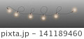 Warm illuminated light bulbs creating a decorative garland effect with transparent background 141189460