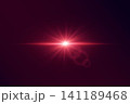 Red light source emitting radiant rays and a horizontal lens flare on a dark background 141189468