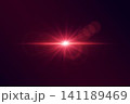 Red shining lens flare creating a vibrant light effect on dark background 141189469