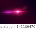 Bright pink lens flare creating star effect with horizontal light rays and bokeh 141189470