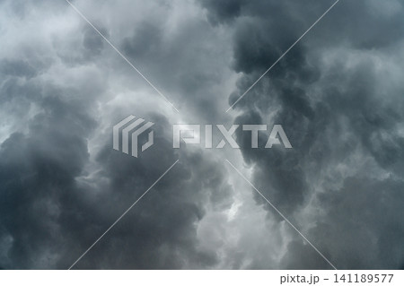 panoramic view of a cloudscape of a sky with a gloomy dark storm clouds panoramic view of a cloudscape of a sky with a gloomy dark storm clouds 141189577