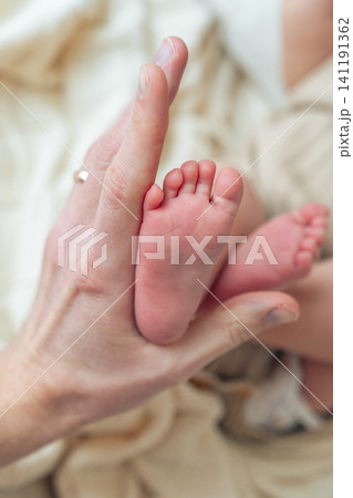 Newborn baby feet with mother hand and copy space. Suitable for parenting, healthcare and baby product advertising Newborn baby feet with mother hand and copy space. Suitable for parenting, healthcare and baby product advertising 141191362