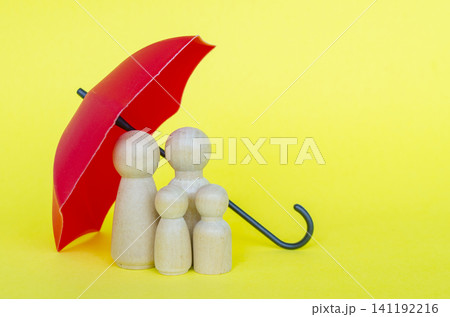 Family figures protected under a red umbrella representing security and insurance with customizable space for text. Family figures protected under a red umbrella representing security and insurance with customizable space for text. 141192216
