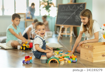 Childrens leisure, supervised children, children playing in living room of kindergarten. 141193279