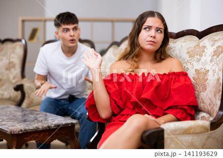 Disgruntled young husband swears at his wife Disgruntled young husband swears at his wife 141193629