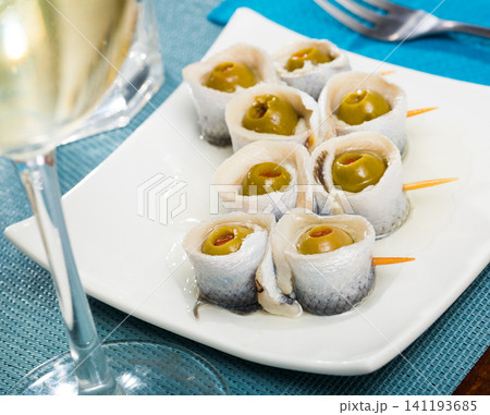 Appetizing herring rolls with olives on skewers Appetizing herring rolls with olives on skewers 141193685
