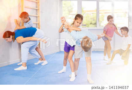 children are working on arm twists children are working on arm twists 141194037