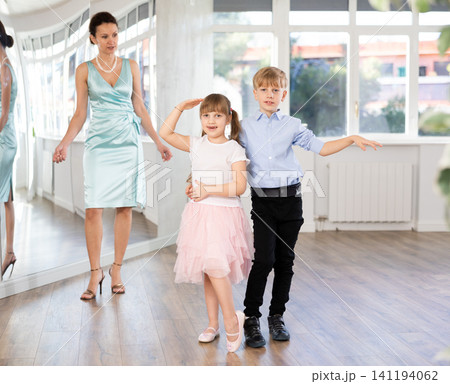 Boy and girl train to dance contemporary vigorous rumba during classes. Boy and girl train to dance contemporary vigorous rumba during classes. 141194062